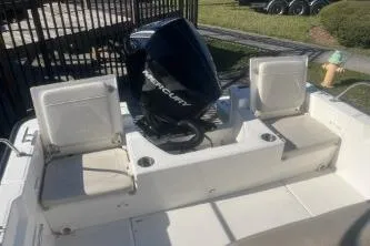 Slide: The Image of 2024 Boston Whaler 210 Montauk boat with Mercury engine, rear seating view. - 10