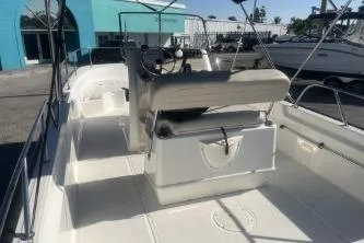 Slide: The Image of 2024 Boston Whaler 210 Montauk boat interior with seating and steering console. - 6