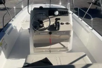 Slide: The Image of 2024 Boston Whaler 210 Montauk boat interior with steering console and seating. - 7