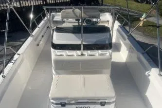 Slide: The Image of 2024 Boston Whaler 210 Montauk boat interior with seating and steering console. - 9