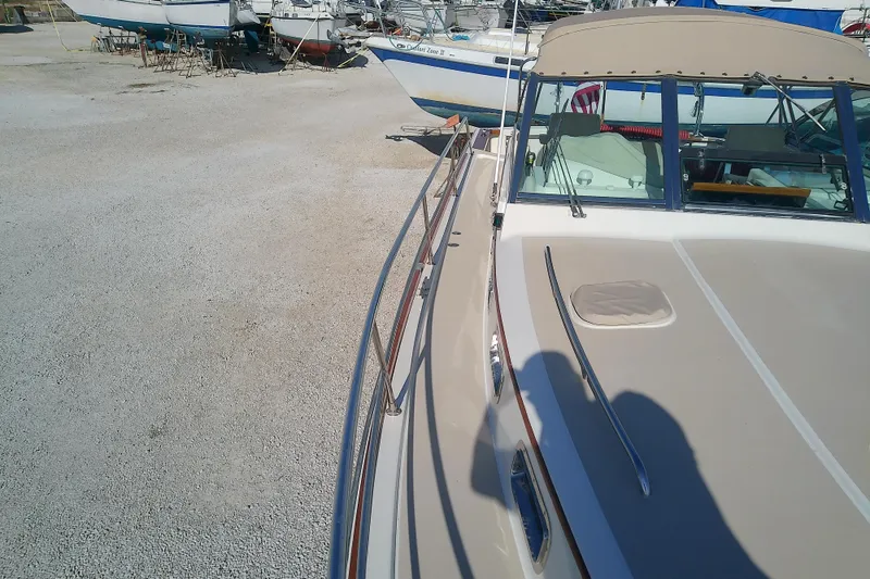 Slide: The Image of 2002 Sabreline 36 Express boat on dry dock, surrounded by other vessels. - 17
