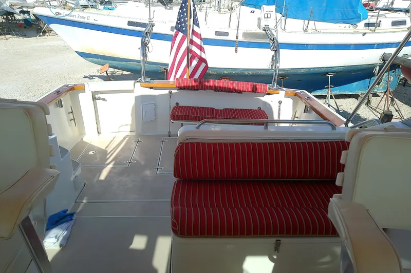 Slide: The Image of 2002 Sabreline 36 Express boat interior with red-striped seating and American flag. - 23