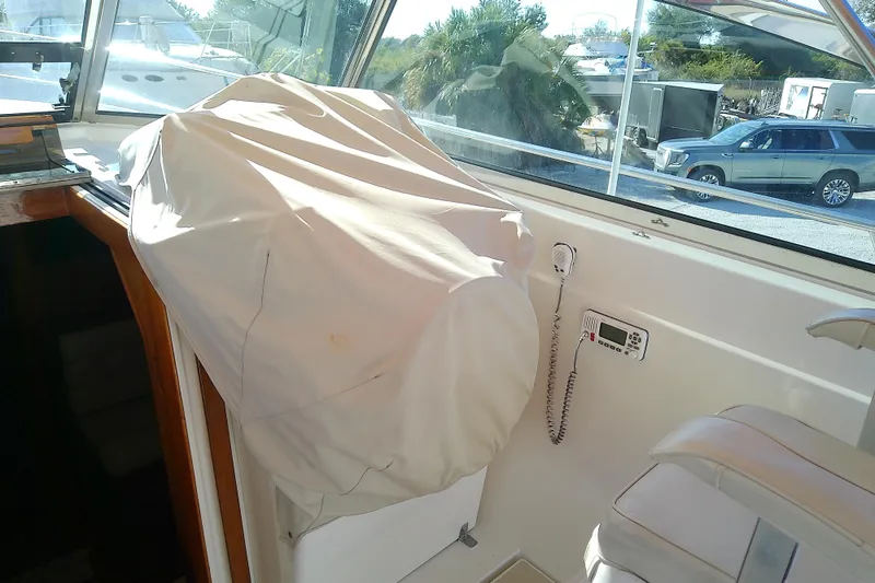 Slide: The Image of Interior of 2002 Sabreline 36 Express boat with covered helm and radio equipment. - 26