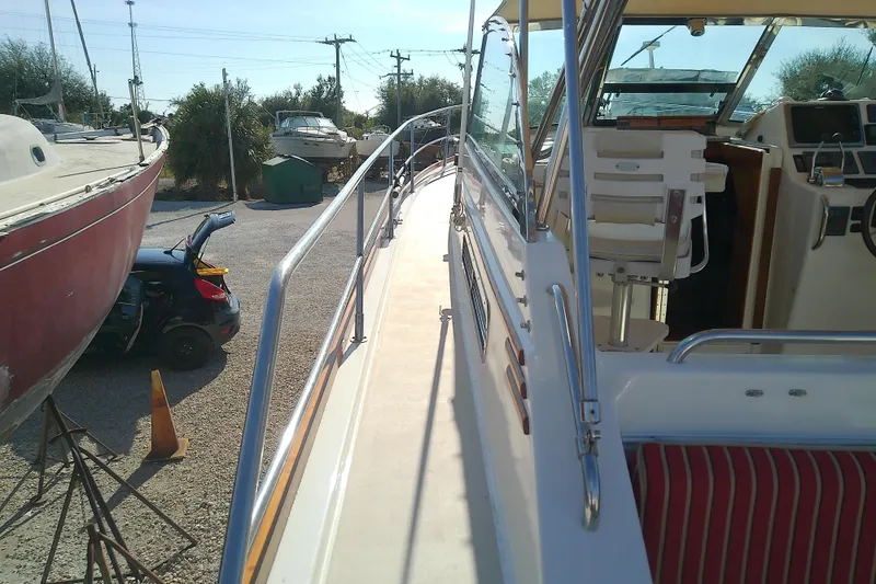 Slide: The Image of 2002 Sabreline 36 Express boat docked, showcasing deck and cockpit area. - 31