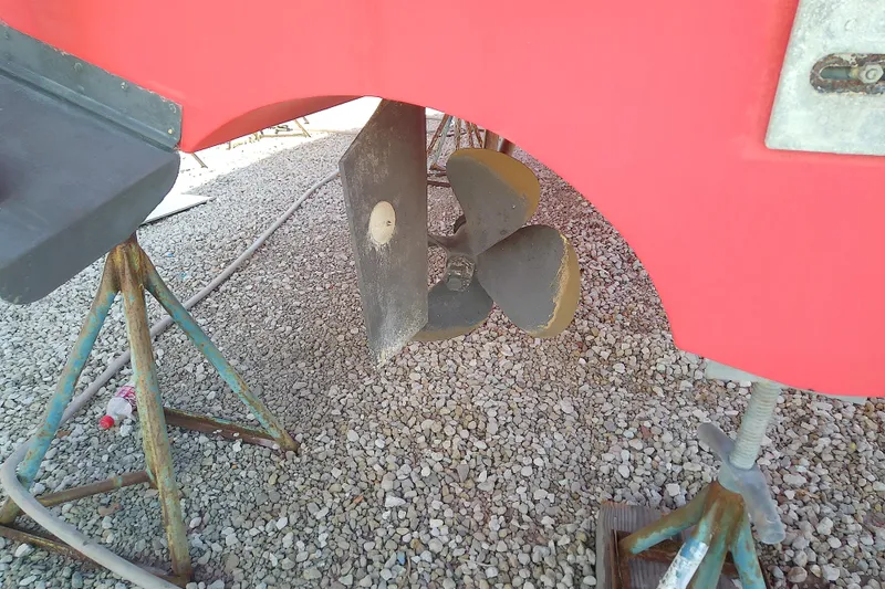 Slide: The Image of Propeller of 2002 Sabreline 36 Express boat on dry dock with red hull. - 45