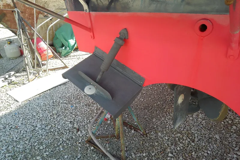 Slide: The Image of 2002 Sabreline 36 Express boat hull with propeller and rudder on gravel. - 46