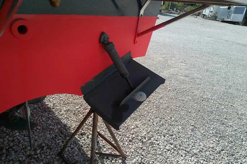 Slide: The Image of 2002 Sabreline 36 Express boat hull with trim tab on gravel surface. - 47