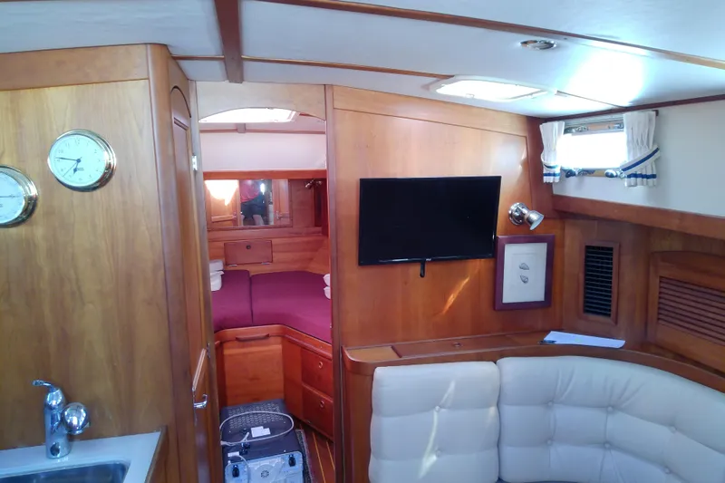 Slide: The Image of Interior of 2002 Sabreline 36 Express yacht with wood finish and cozy seating area. - 51