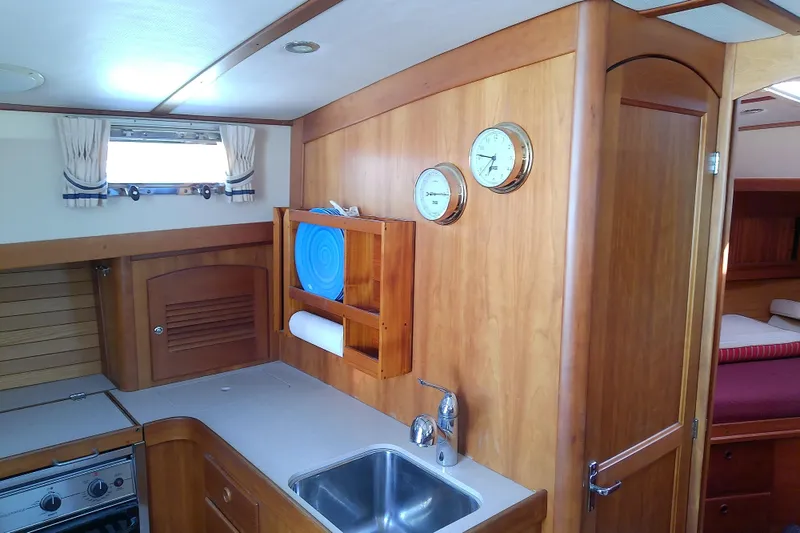 Slide: The Image of Interior of 2002 Sabreline 36 Express yacht with wooden cabinetry and compact kitchen. - 52