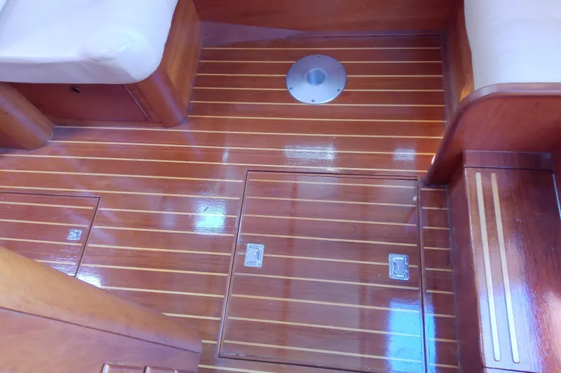Slide: The Image of Polished wooden floor of 2002 Sabreline 36 Express boat interior with storage compartments. - 59