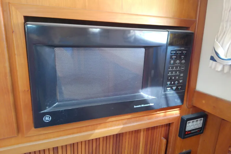 Slide: The Image of Built-in GE microwave in 2002 Sabreline 36 Express boat kitchen. - 61