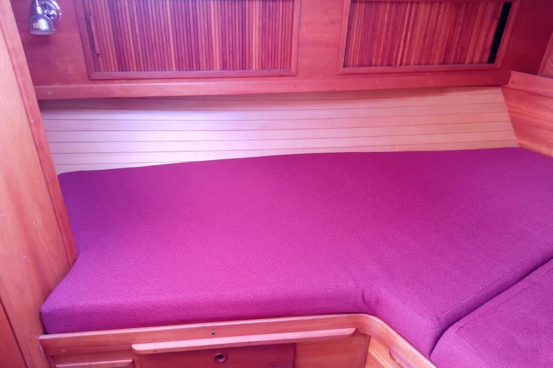 Slide: The Image of 2002 Sabreline 36 Express cabin with purple bedding and wooden interior. - 70
