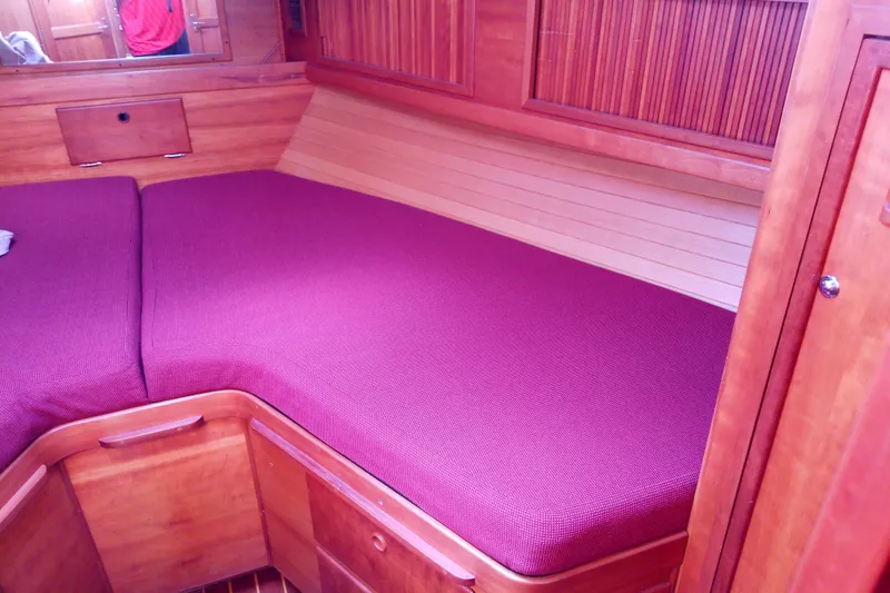 Slide: The Image of Interior cabin of 2002 Sabreline 36 Express with wooden finish and maroon upholstery. - 71