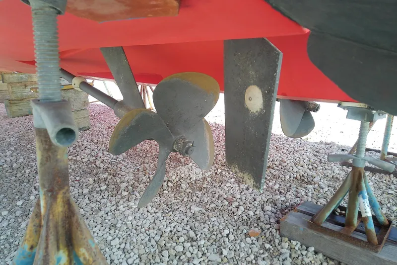 Slide: The Image of 2002 Sabreline 36 Express boat propeller and rudder on gravel. - 8