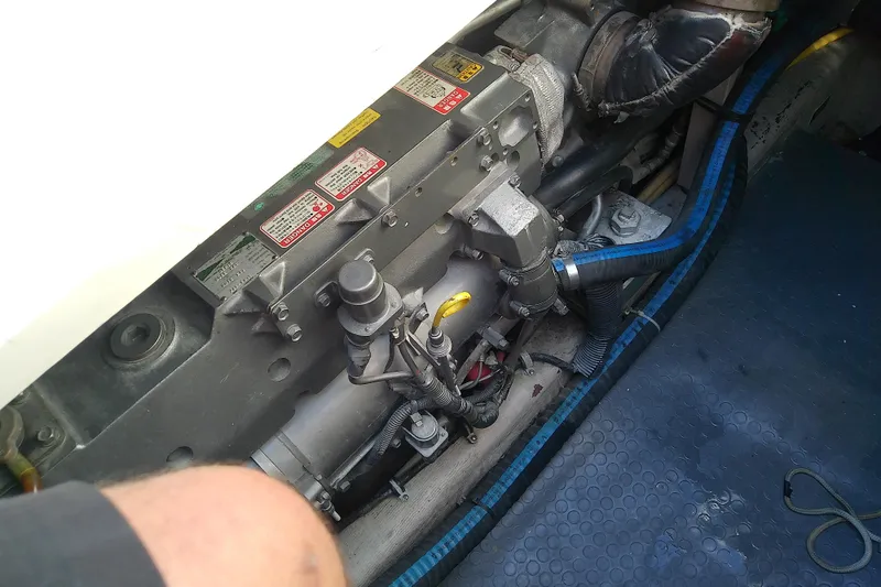 Slide: The Image of Engine compartment of a 2002 Sabreline 36 Express boat, showcasing mechanical components. - 80
