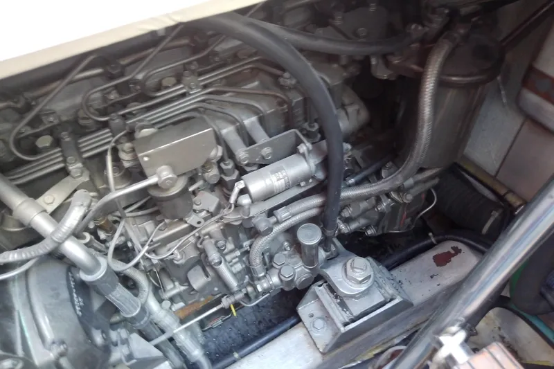 Slide: The Image of Engine compartment of a 2002 Sabreline 36 Express boat, showcasing intricate mechanical components. - 83