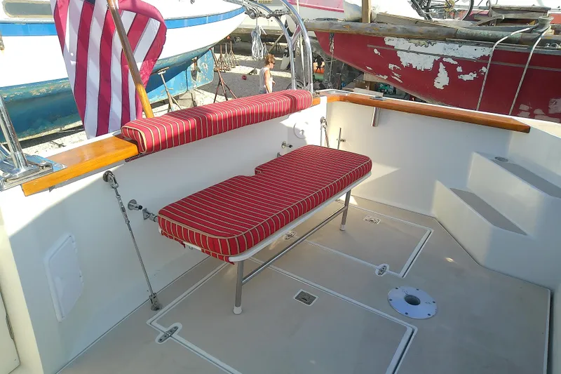 Slide: The Image of 2002 Sabreline 36 Express boat deck with striped seating and American flag. - 13