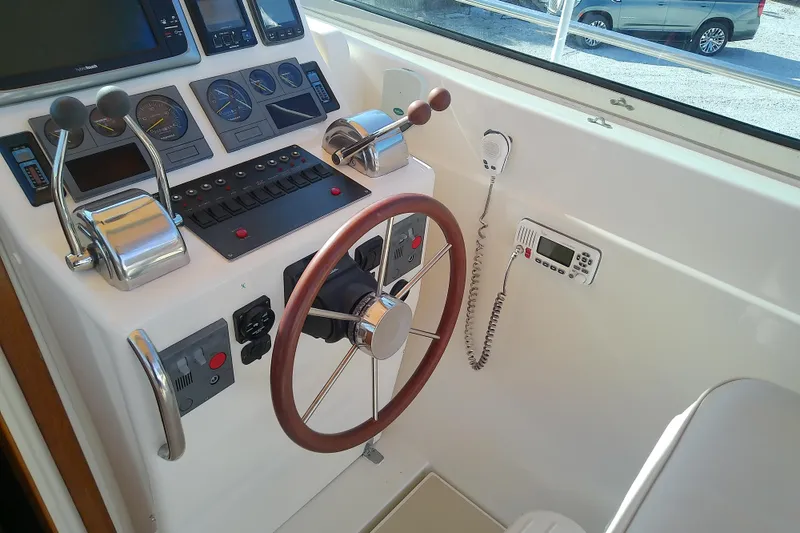 Slide: The Image of Control panel of a 2002 Sabreline 36 Express boat with steering wheel and gauges. - 29