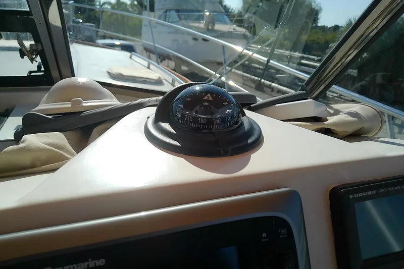 Slide: The Image of 2002 Sabreline 36 Express boat dashboard with compass and navigation equipment. - 33