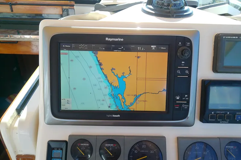 Slide: The Image of Raymarine navigation system on 2002 Sabreline 36 Express boat dashboard, displaying nautical chart. - 34