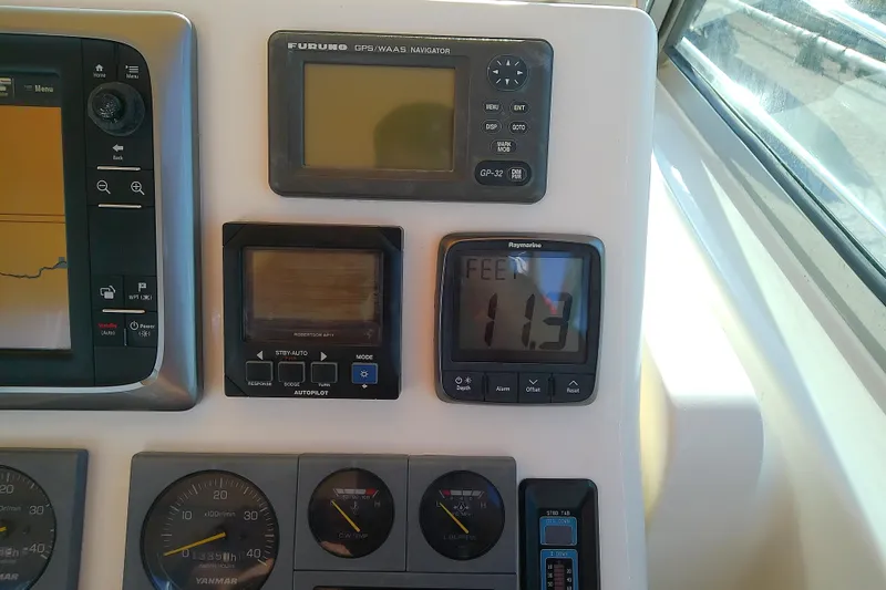 Slide: The Image of Boat dashboard with navigation instruments on a 2002 Sabreline 36 Express. - 35