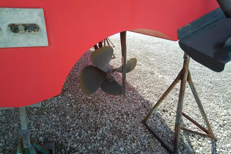 Slide: The Image of Propeller of 2002 Sabreline 36 Express boat on gravel, supported by stands. - 44