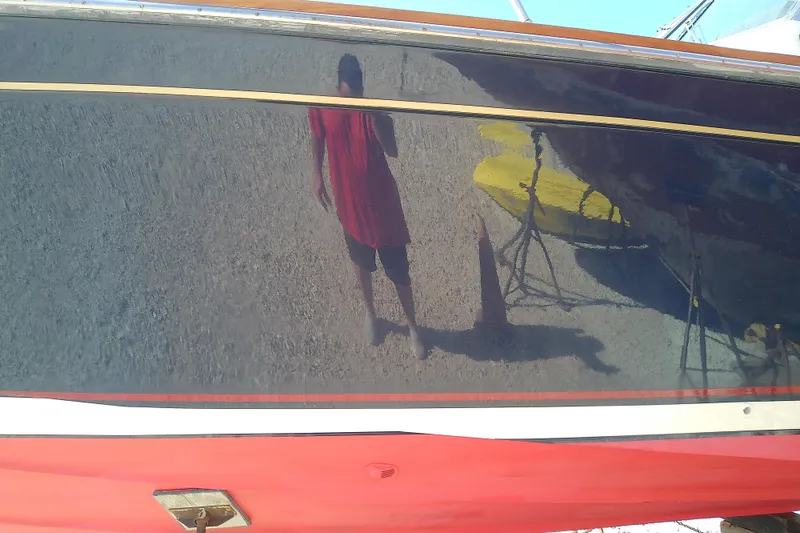 Slide: The Image of Reflection on 2002 Sabreline 36 Express boat hull with person in red shirt. - 49