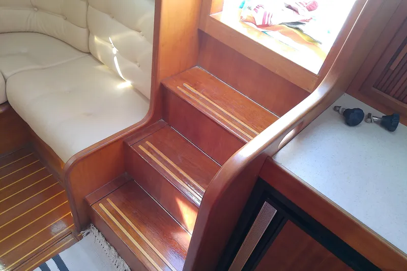 Slide: The Image of Interior of 2002 Sabreline 36 Express with wooden stairs and cushioned seating. - 55