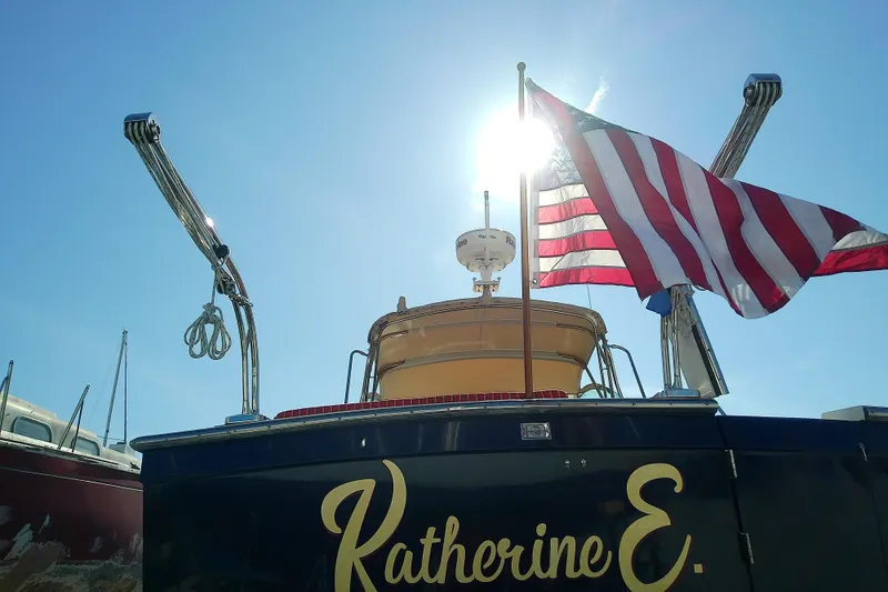 Slide: The Image of 2002 Sabreline 36 Express boat with American flag, sunlit backdrop. - 6