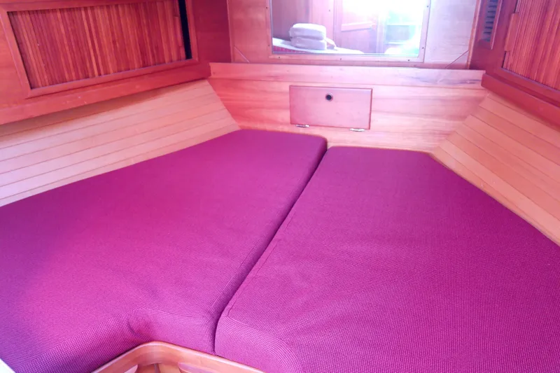 Slide: The Image of Cozy cabin interior of 2002 Sabreline 36 Express with purple cushions and wooden paneling. - 67