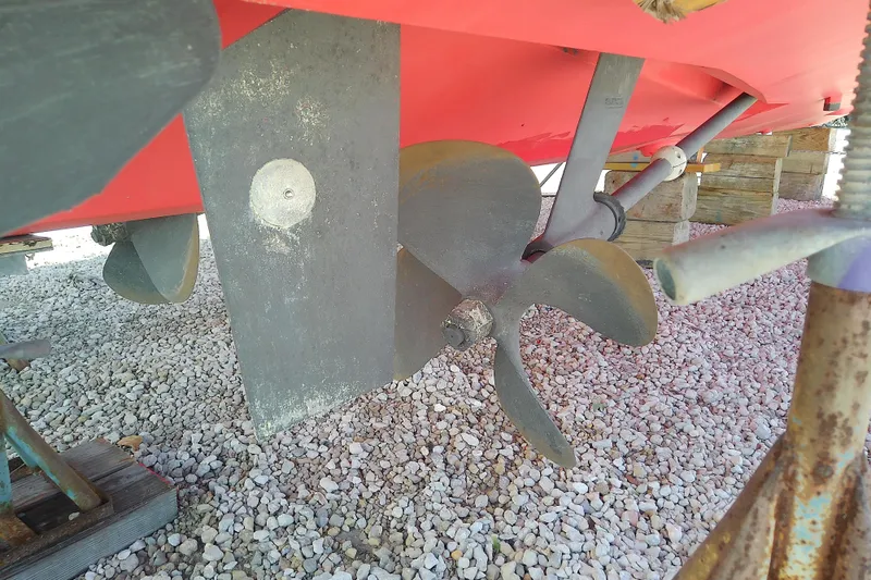 Slide: The Image of Propeller and rudder of 2002 Sabreline 36 Express boat on gravel surface. - 7
