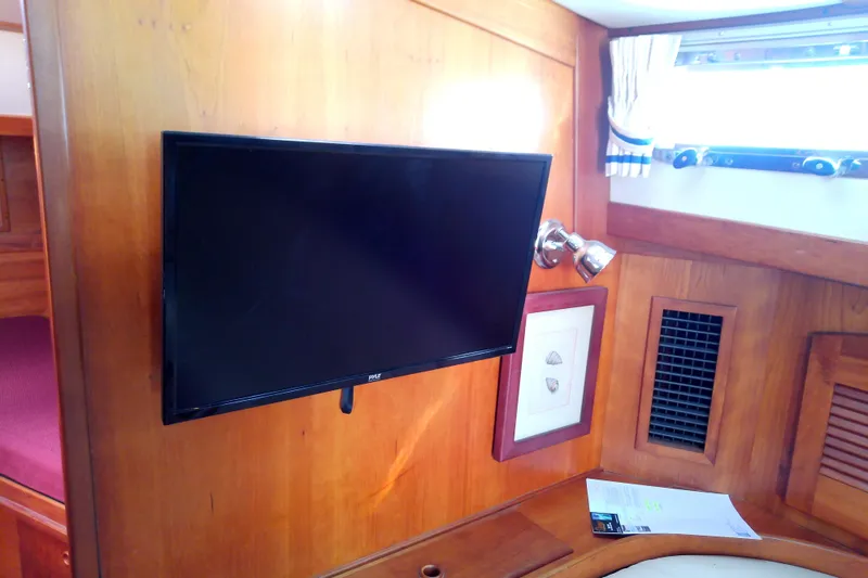 Slide: The Image of Interior of 2002 Sabreline 36 Express with mounted TV and wooden paneling. - 76