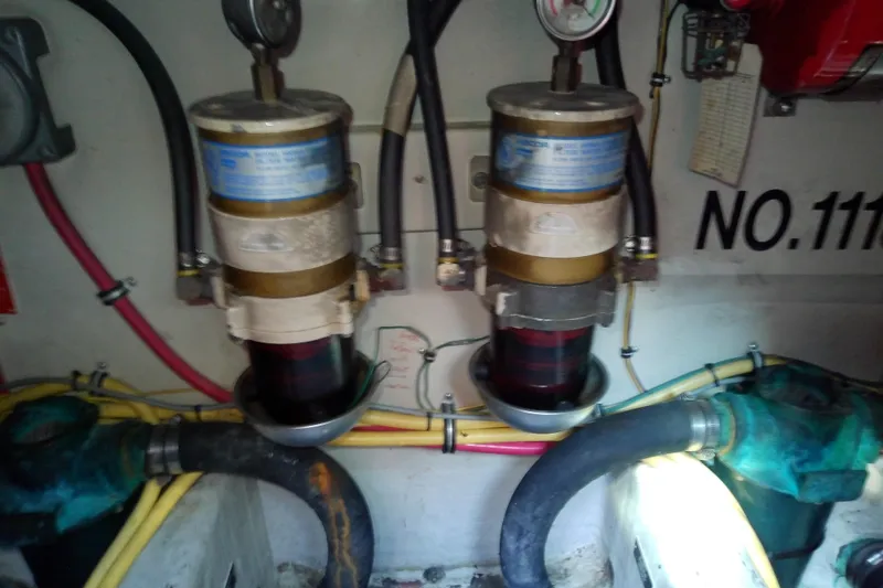 Slide: The Image of Engine room of 2002 Sabreline 36 Express with fuel filters and hoses. - 82