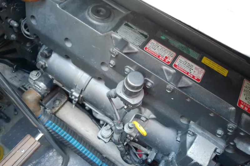 Slide: The Image of Engine compartment of a 2002 Sabreline 36 Express boat with visible warning labels. - 84
