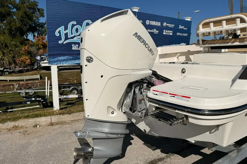 Slide: The Image of 2026 Bayliner Trophy T22CC boat with T-top under a clear blue sky. - 12