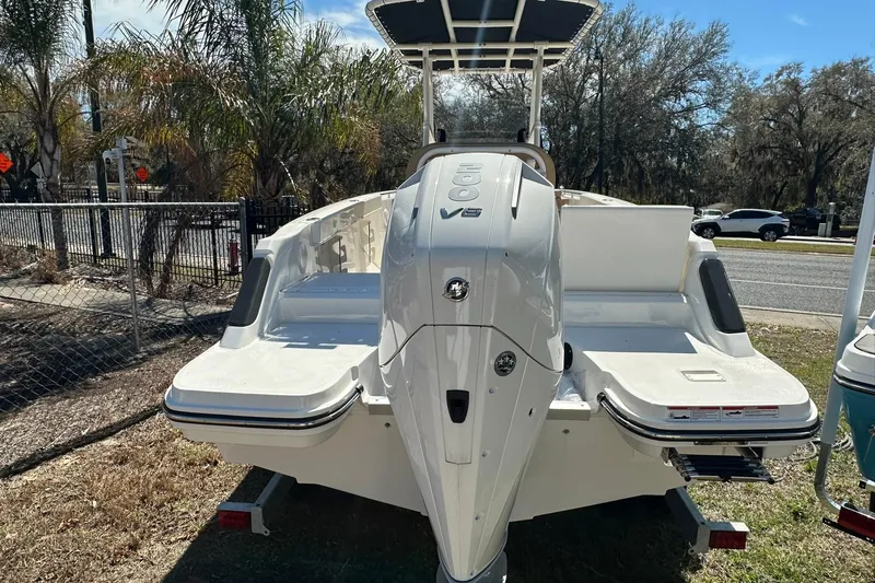 Slide: The Image of 2026 Bayliner Trophy T22CC boat with V6 engine, parked outdoors. - 16