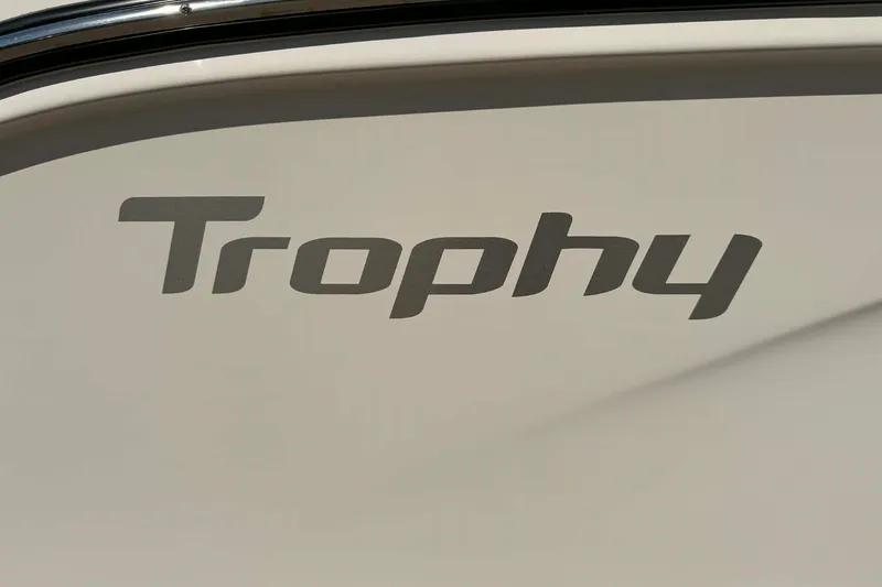 Slide: The Image of 2026 Bayliner Trophy T22CC boat side view with model name visible. - 2