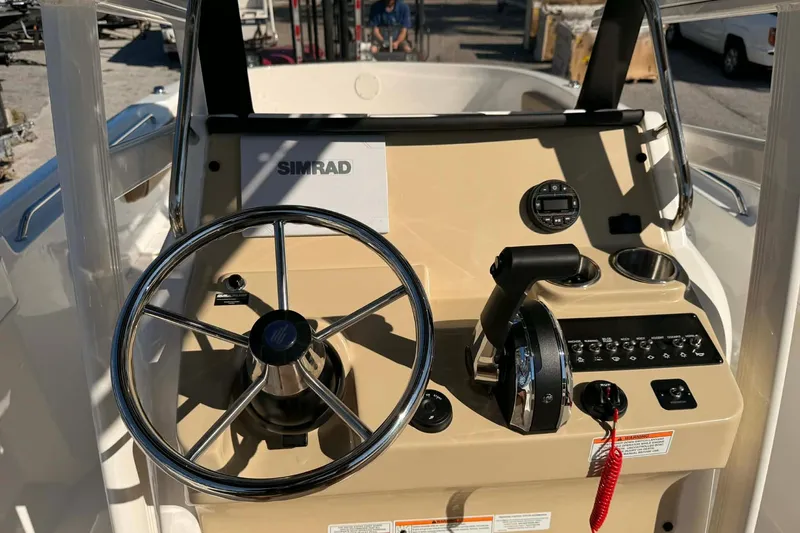 Slide: The Image of 2026 Bayliner Trophy T22CC boat interior with steering console and seating. - 4