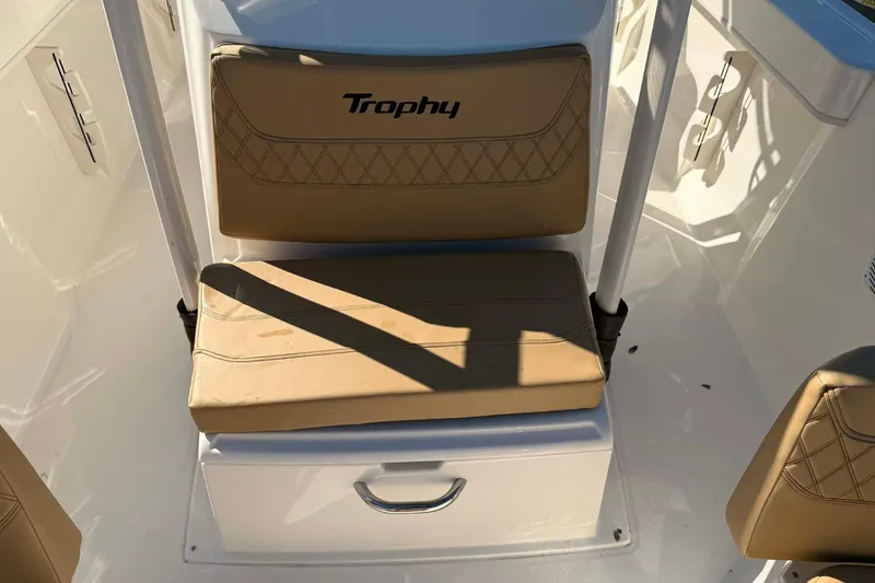 Slide: The Image of 2026 Bayliner Trophy T22CC boat interior with tan cushioned seating. - 6