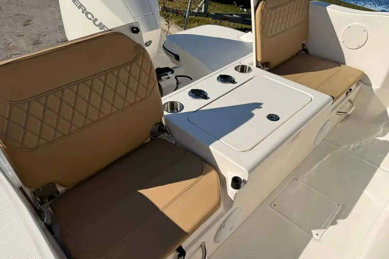 Slide: The Image of 2026 Bayliner Trophy T22CC boat with tan seating and sleek design. - 9