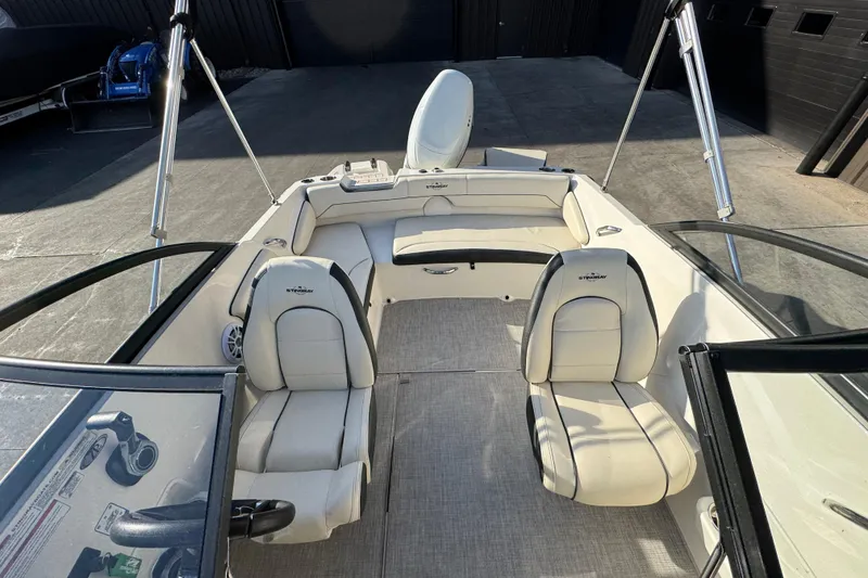 Slide: The Image of 2022 Stingray 191 DC boat interior with white seating and modern design. - 11