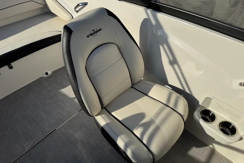 Slide: The Image of 2022 Stingray 191 DC boat interior with cushioned seating and cup holders. - 18