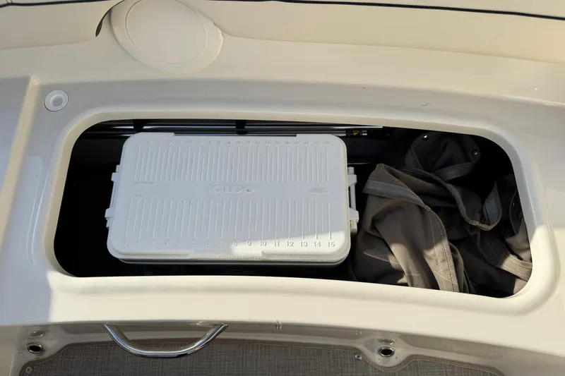 Slide: The Image of Storage compartment in 2022 Stingray 191 DC boat with cooler and bag. - 20