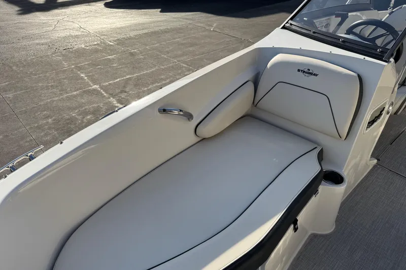 Slide: The Image of 2022 Stingray 191 DC boat interior with white seating and sleek design. - 9