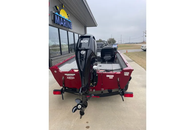 Slide: The Image of 2021 Tracker Pro Guide V-16 SC boat with 50 HP engine at marine dealership. - 5