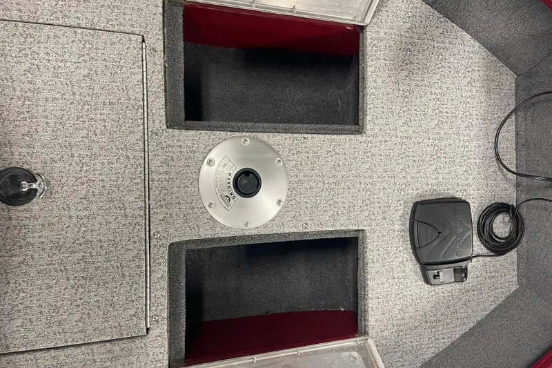 Slide: The Image of 2021 Tracker Pro Guide V-16 SC boat interior with storage compartments and pedal control. - 6