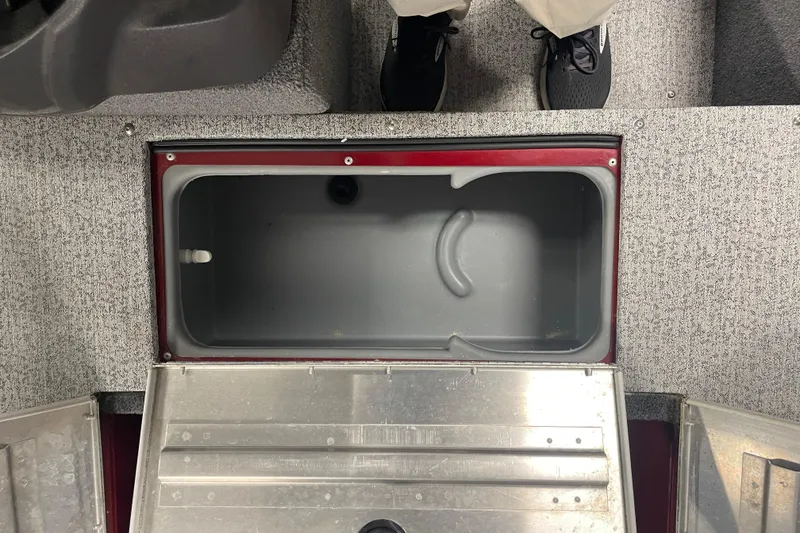 Slide: The Image of 2021 Tracker Pro Guide V-16 SC boat storage compartment with open lid, gray interior. - 7