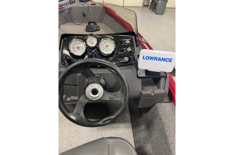 Slide: The Image of 2021 Tracker Pro Guide V-16 SC dashboard with steering wheel and Lowrance display. - 8