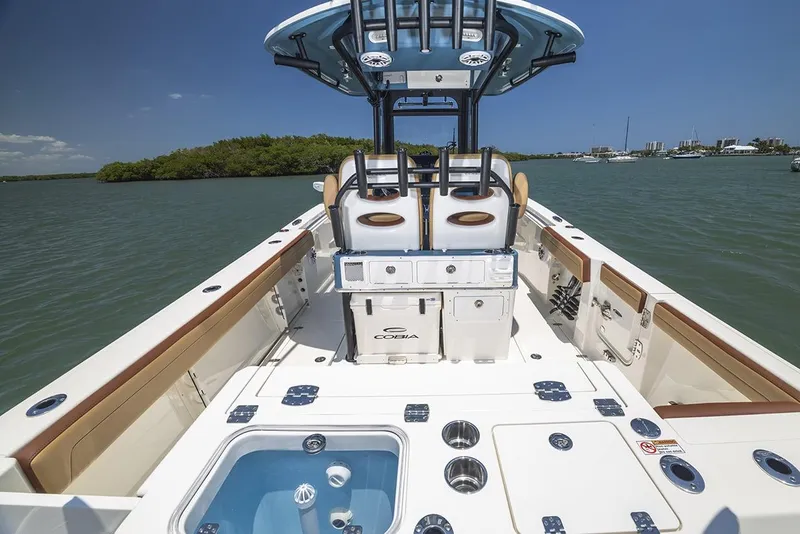 Slide: The Image of Manufacturer Provided Image: 2025 Cobia 265 Center Console Open boat on water, featuring spacious deck and seating. - 16