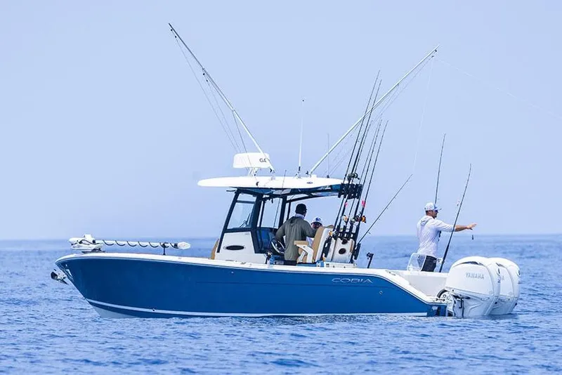 Slide: The Image of Manufacturer Provided Image: 2025 Cobia 265 Center Console Open fishing boat on calm ocean waters. - 3